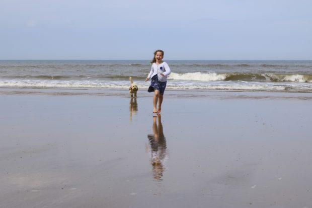 girl on beach in dog-friendly charleston